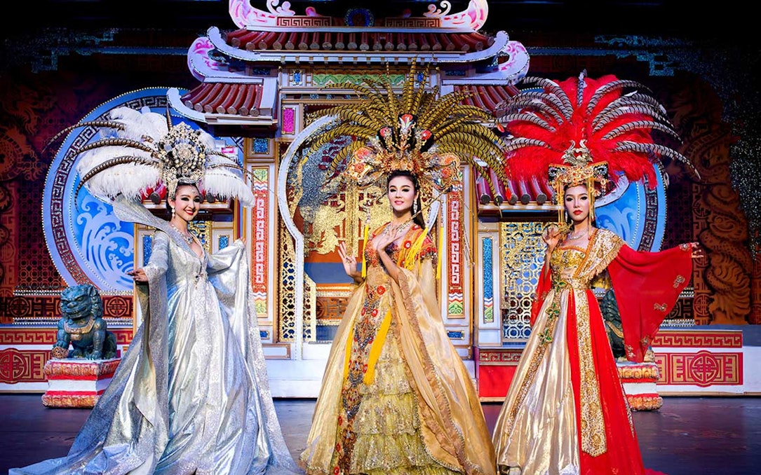 Performers in elaborate costumes on stage at Aphrodite Cabaret Show, Thailand.