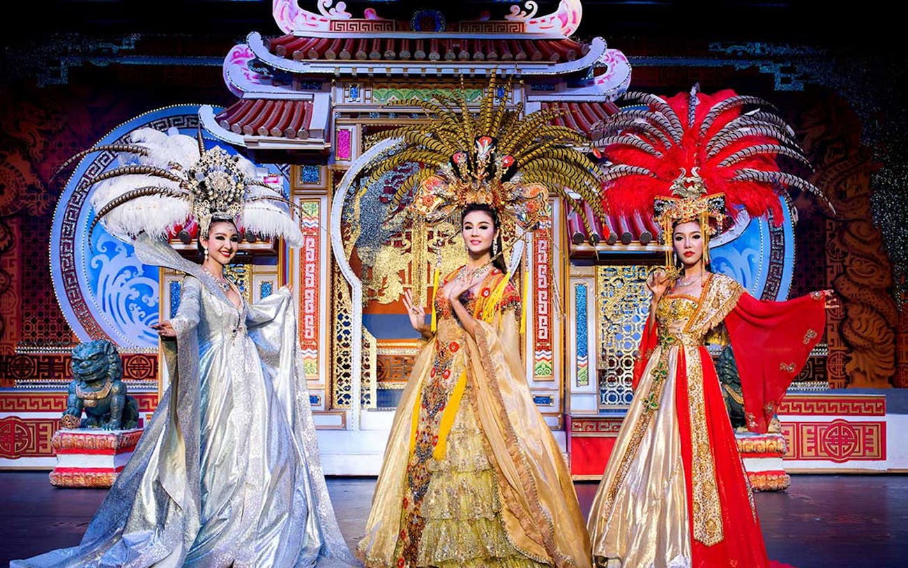 Performers in elaborate costumes on stage at Aphrodite Cabaret Show, Thailand.