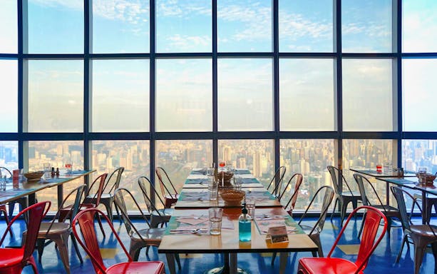 Dining tables with city view at Baiyoke Floating Market Buffet, Baiyoke Sky Hotel's 75th Floor.