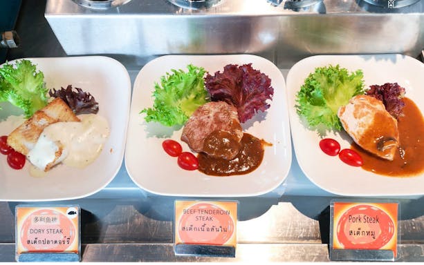 Dory, beef, and pork steaks with sauce and greens at Baiyoke Floating Market Buffet, Baiyoke Sky Hotel.
