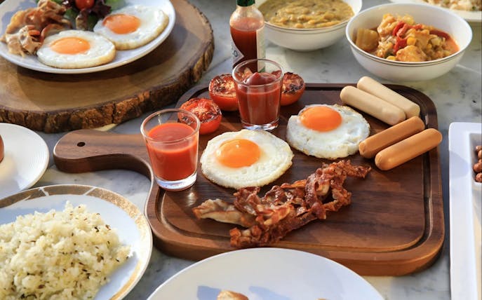 Bangkok Balcony Buffet breakfast with eggs, bacon, sausages, and rice at Baiyoke Sky Hotel's 81st floor.