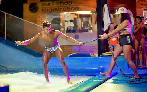 Man learning to surf at Surf House Phuket Kata Beach indoor wave pool.