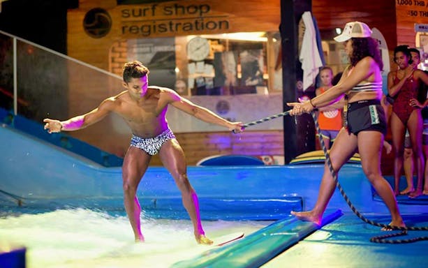 Man learning to surf at Surf House Phuket Kata Beach indoor wave pool.