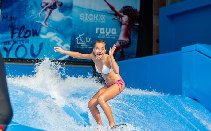 Surfer enjoying wave simulator at Surf House Phuket Kata Beach.