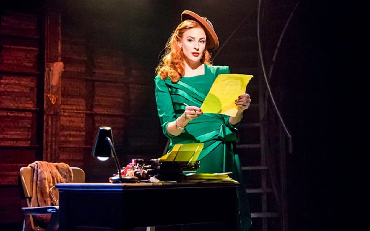Woman in green dress reading a script on stage, City of Angels performance.