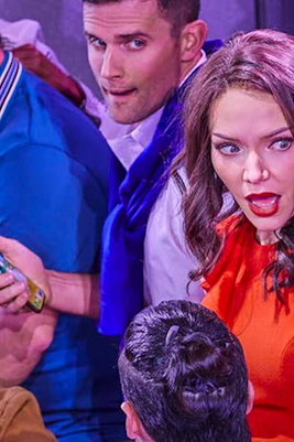 Group of people reacting with surprise during a theater performance.