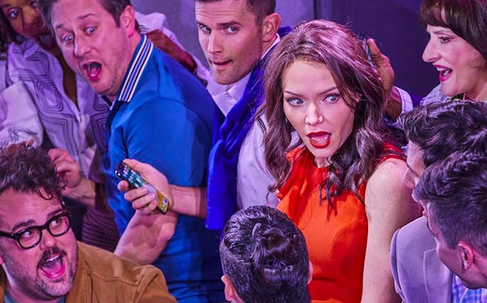 Group of people reacting with surprise during a theater performance.