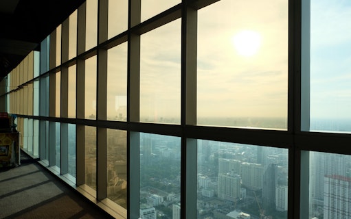 View from Baiyoke Sky Hotel observation deck overlooking Bangkok cityscape.