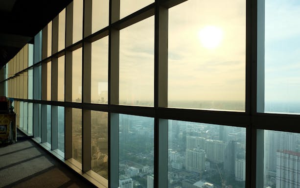 View from Baiyoke Sky Hotel observation deck overlooking Bangkok cityscape.