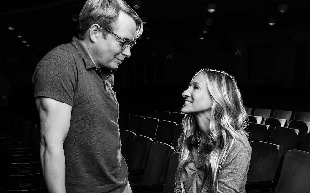 Two people smiling at each other in a theater setting for Plaza Suite.