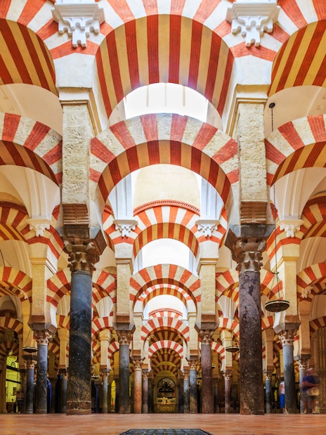Córdoba Cathedral-Mosque interior with red and white arches and columns.