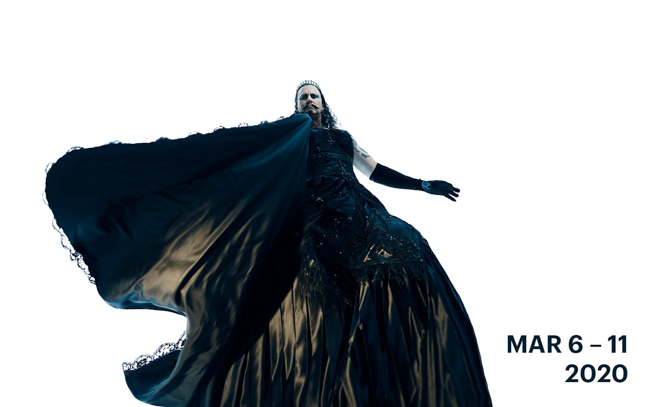 Performer in dramatic black costume from Faust production.