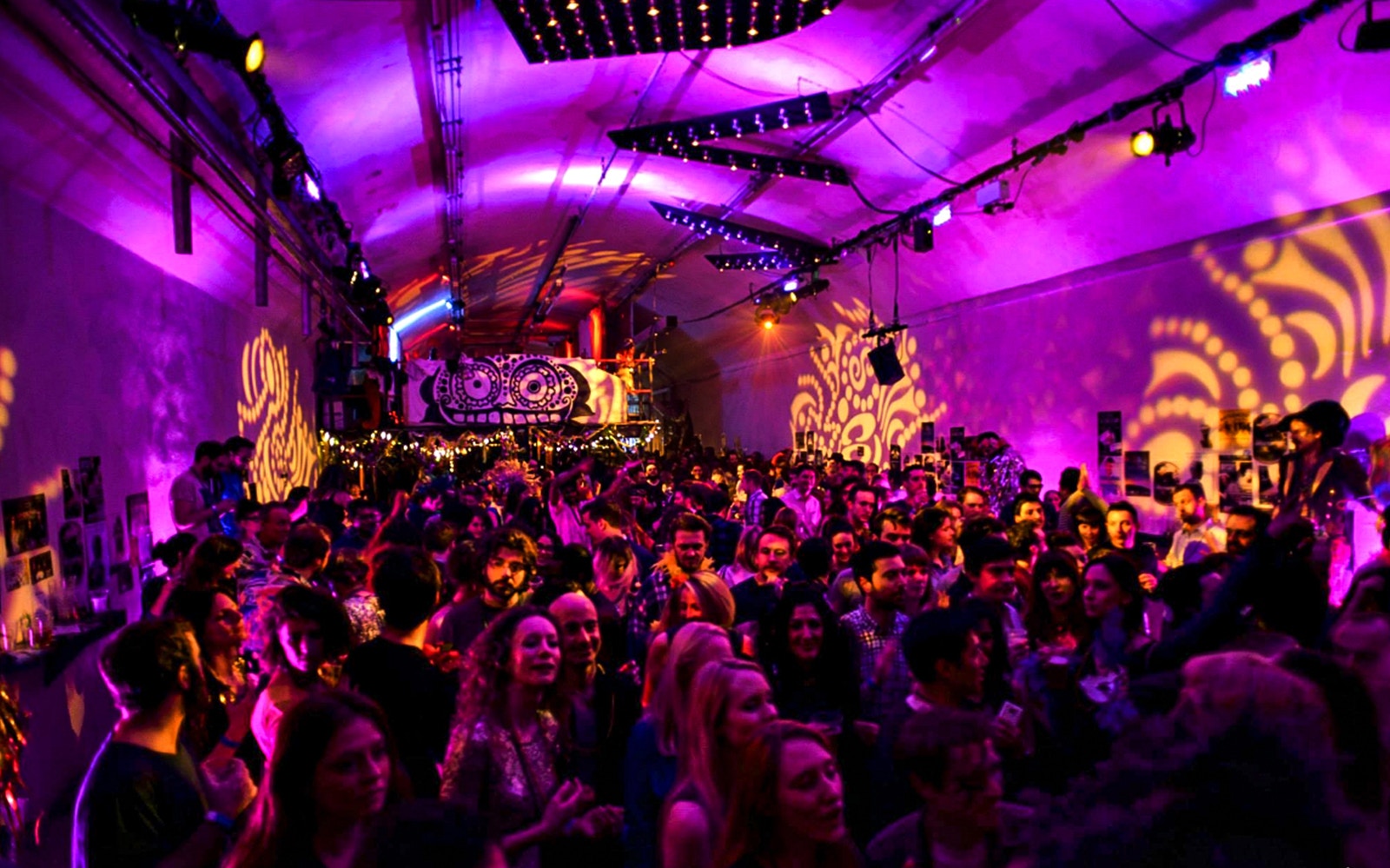 Crowd enjoying New Year's Eve party with vibrant lights at The Vaults.