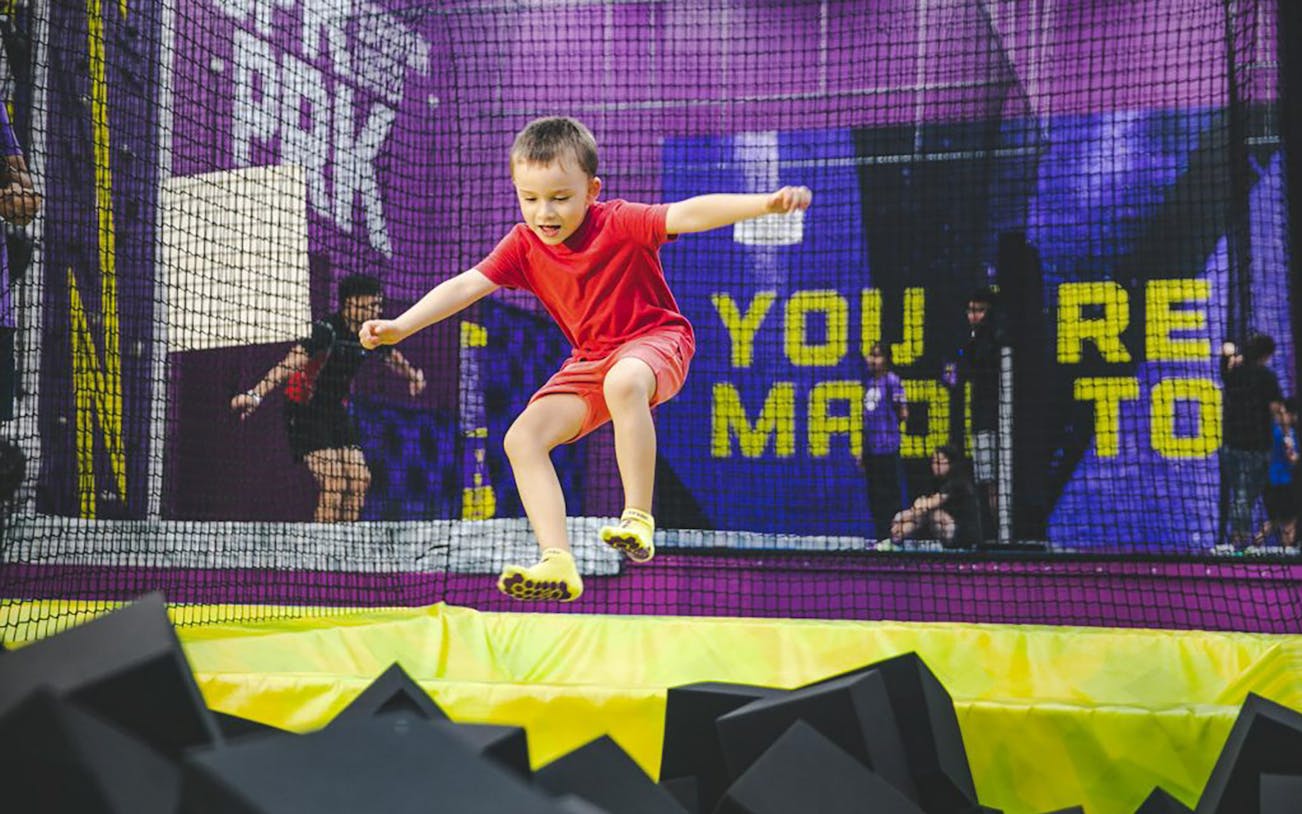 Child jumping into foam pit at Super Park Bangkok Indoor Activity Park.