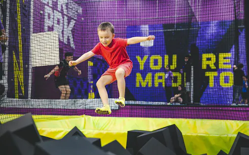 Child jumping into foam pit at Super Park Bangkok Indoor Activity Park.