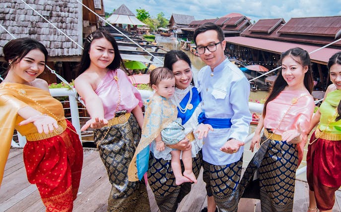 Group in traditional attire at Pattaya Floating Market, Thailand.
