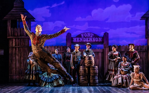 Performer leaping on stage during "Curtains" musical at Fort Henderson set.