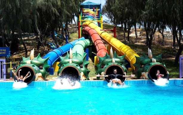 Colorful dragon-themed water slides at Dreamland Aquapark.