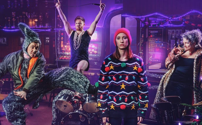 Performers in colorful costumes at Cinderella show in the Vaults, featuring a festive setting.