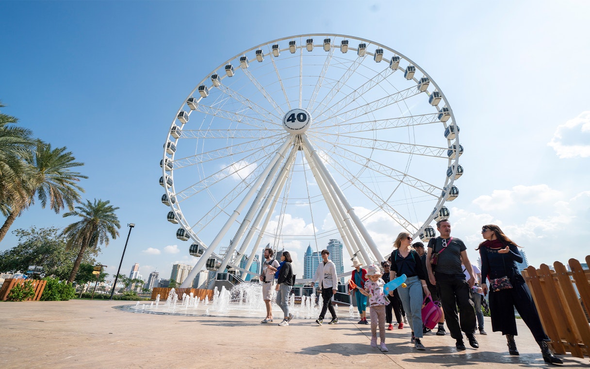 Ferris wheel and visitors at Al Montazah Water Park, Sharjah.