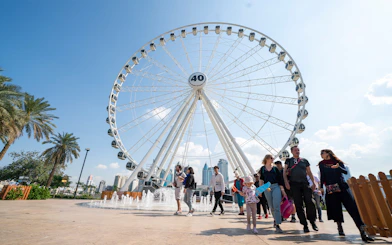 Ferris wheel and visitors at Al Montazah Water Park, Sharjah.