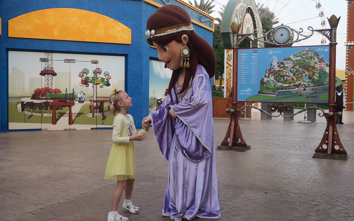 Child meeting a character at Al Montazah Water Park, Sharjah.