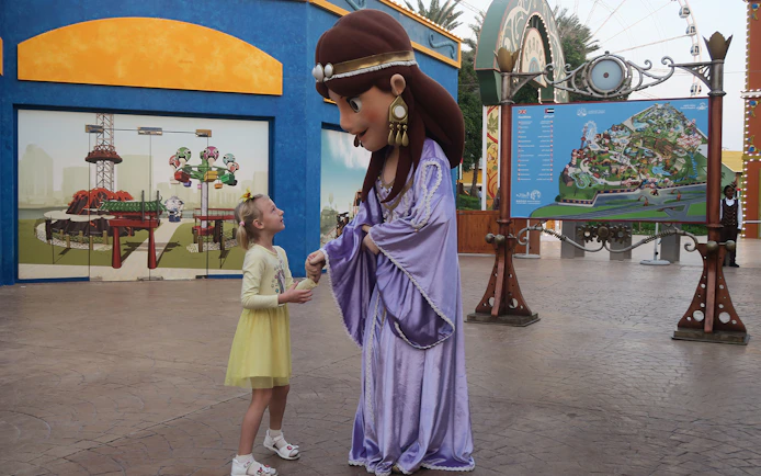 Child meeting a character at Al Montazah Water Park, Sharjah.