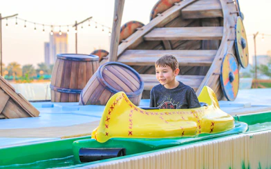 Child enjoying a water ride at Al Montazah Water Park, Sharjah.