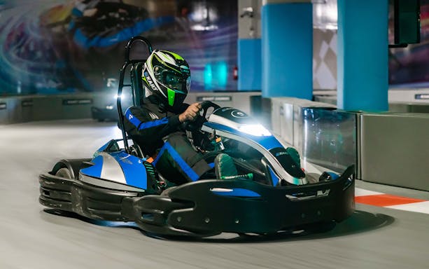 Kart racer navigating track at EKart Zabeel Karting Zone, Dubai Mall.