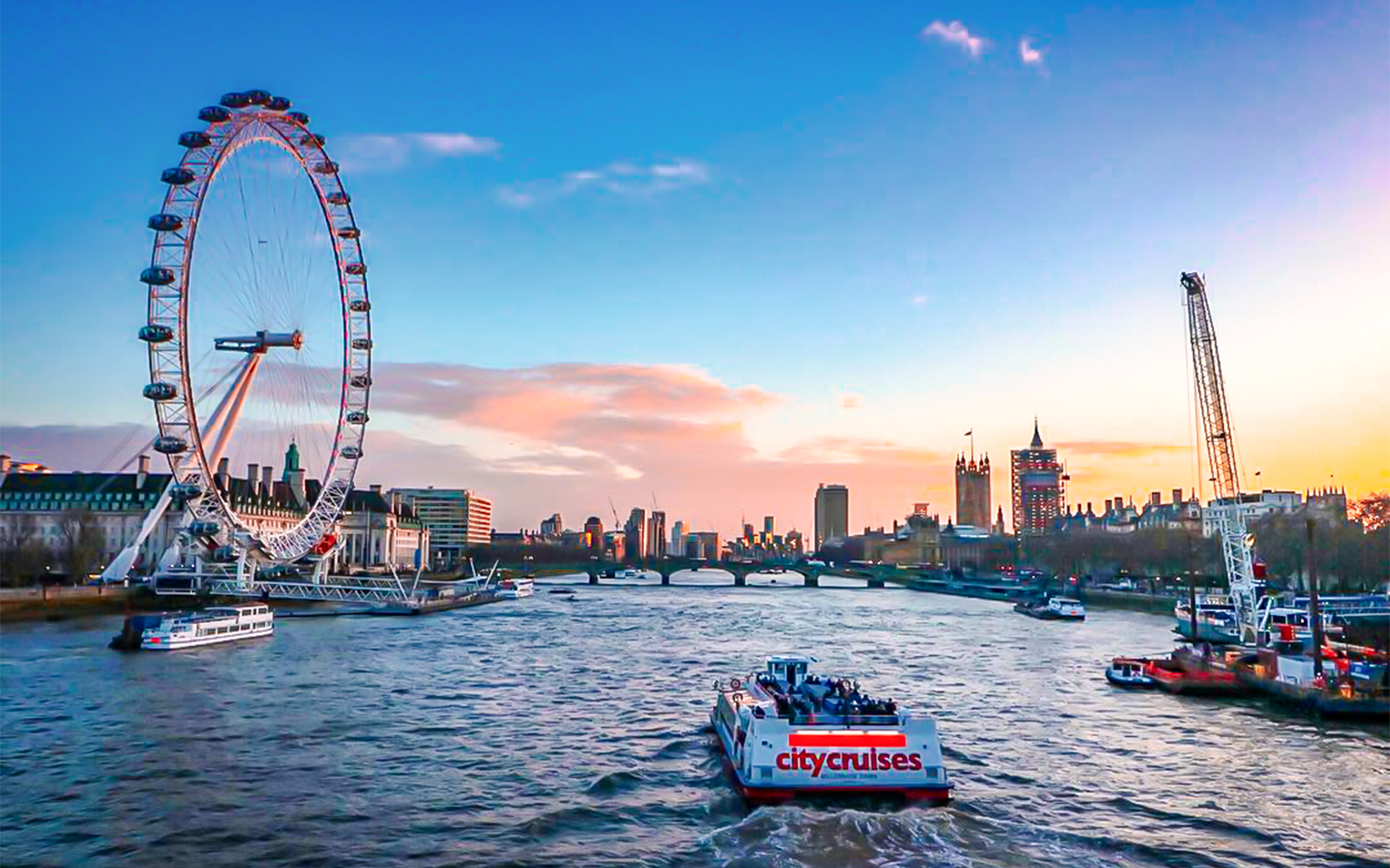 River cruise on the Thames with view of the London Eye and city skyline.