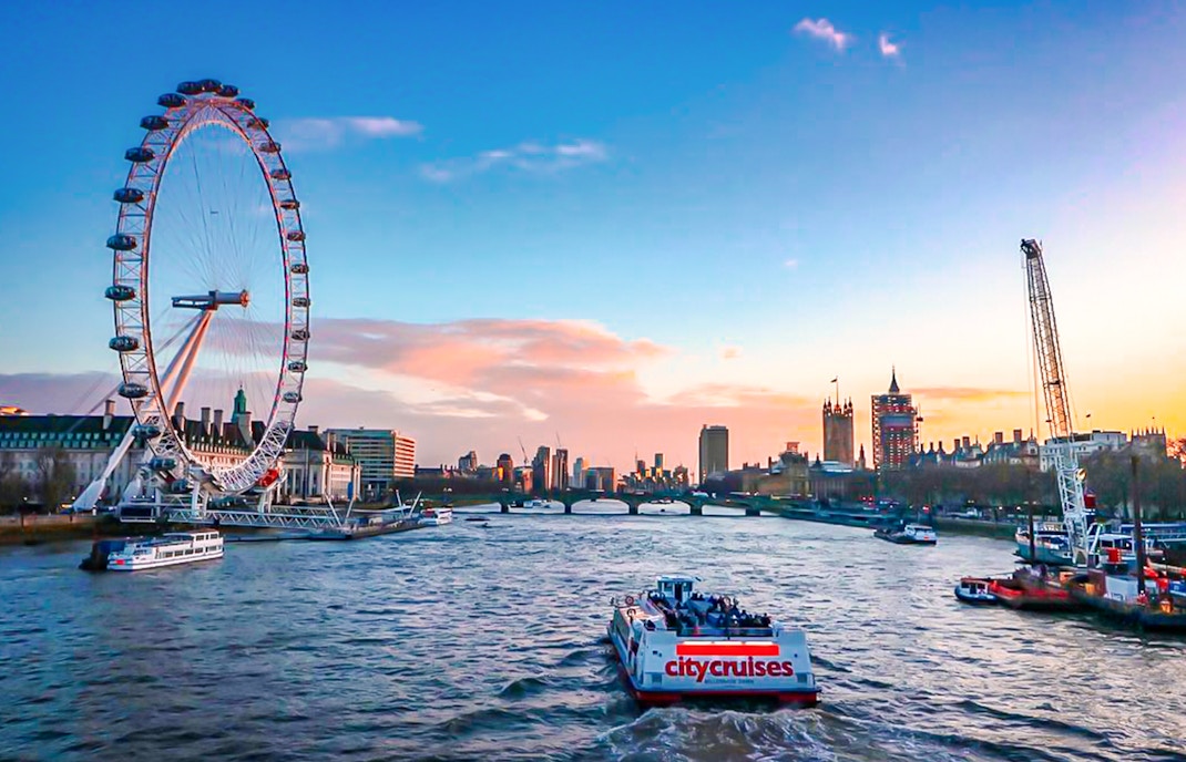 River cruise on the Thames with view of the London Eye and city skyline.