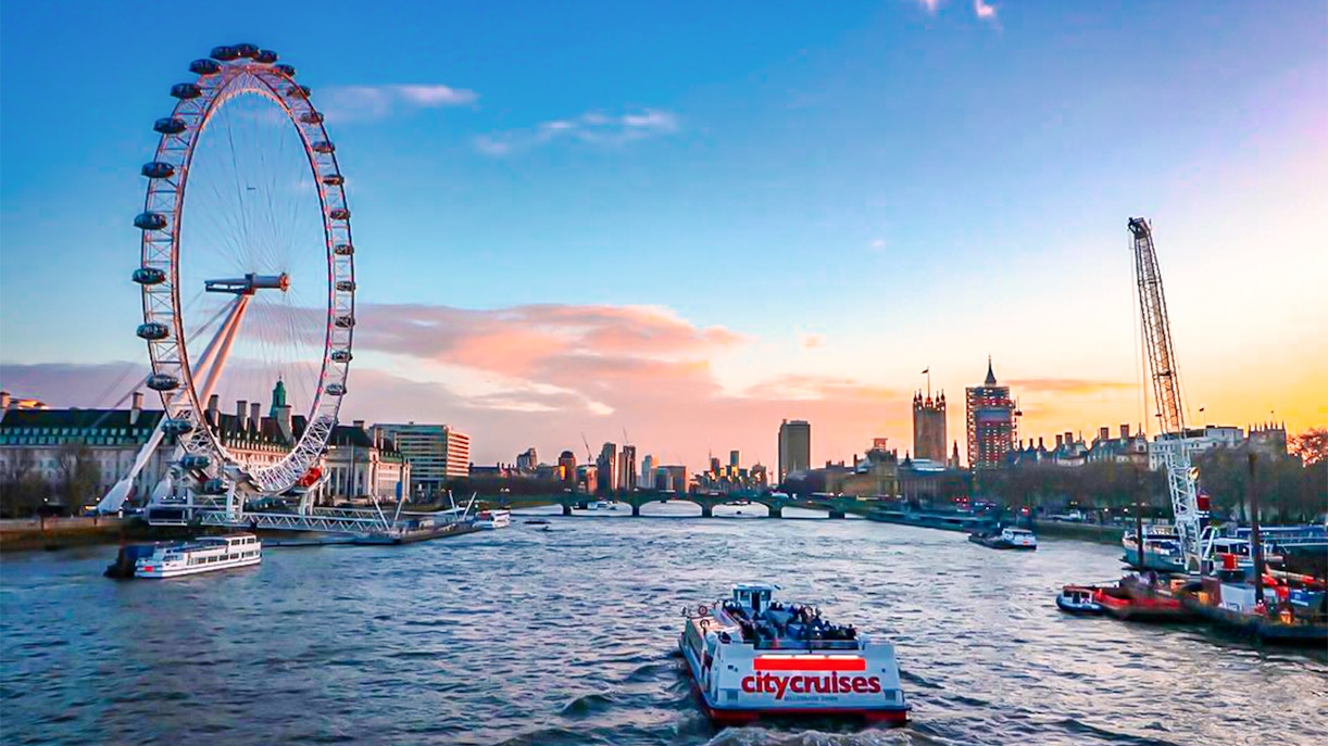 River cruise on the Thames with view of the London Eye and city skyline.