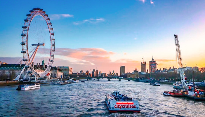 River cruise on the Thames with view of the London Eye and city skyline.