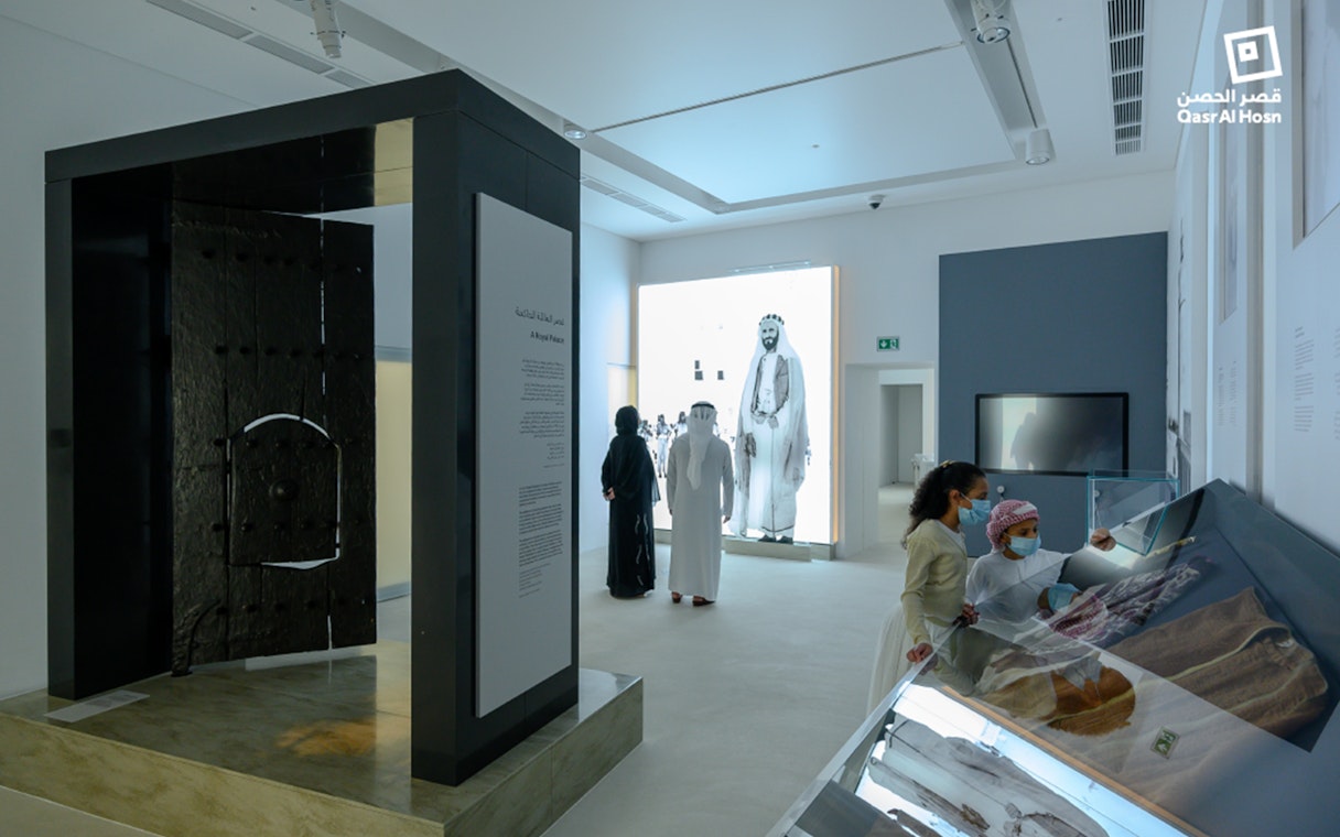 Visitors exploring exhibits at Qasr Al Hosn museum in Abu Dhabi.