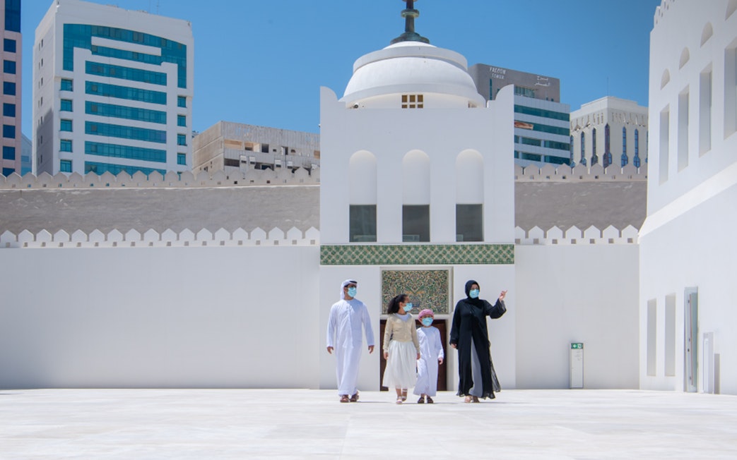 Visitors exploring Qasr Al Hosn courtyard in Abu Dhabi.