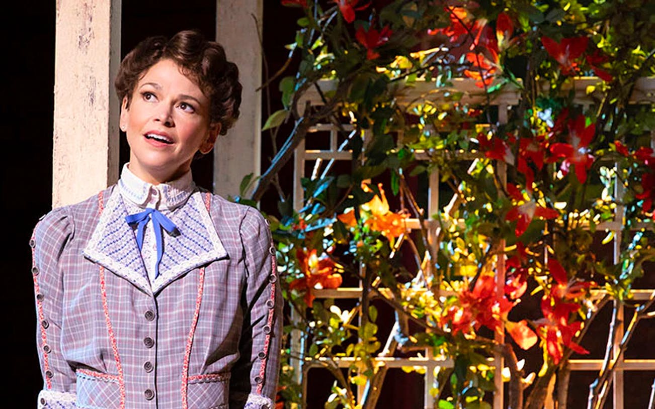 Performer in period costume on stage during "The Music Man" show.