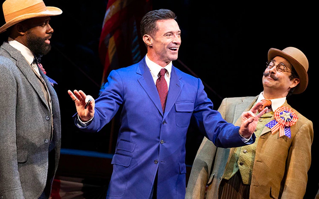 Three actors performing a scene from "The Music Man" on stage.
