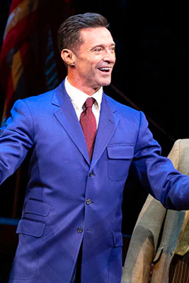 Three actors performing a scene from "The Music Man" on stage.