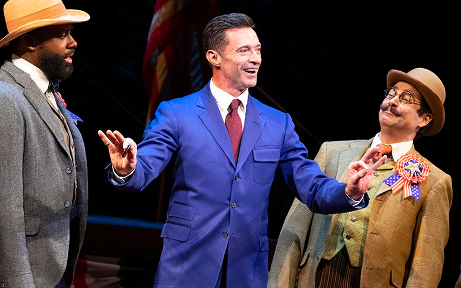 Three actors performing a scene from "The Music Man" on stage.