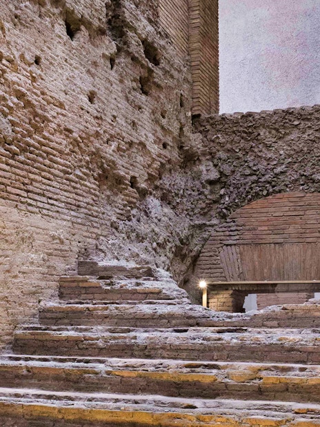 Ancient brick steps in Rome's Navona Square underground passage.