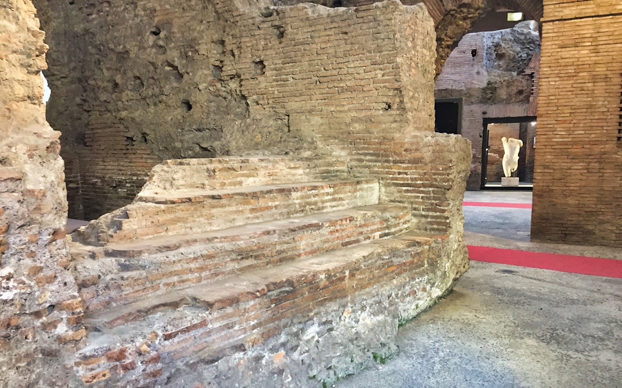 Ancient brick ruins in Rome's underground near Navona Square and Trevi district.