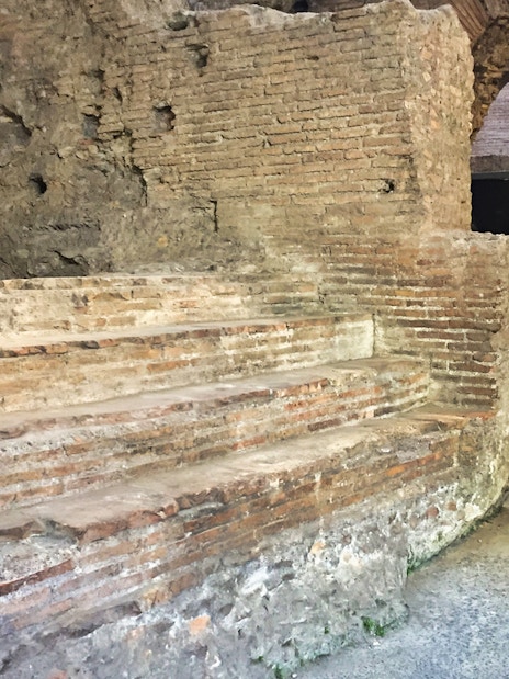 Ancient brick ruins in Rome's underground near Navona Square and Trevi district.