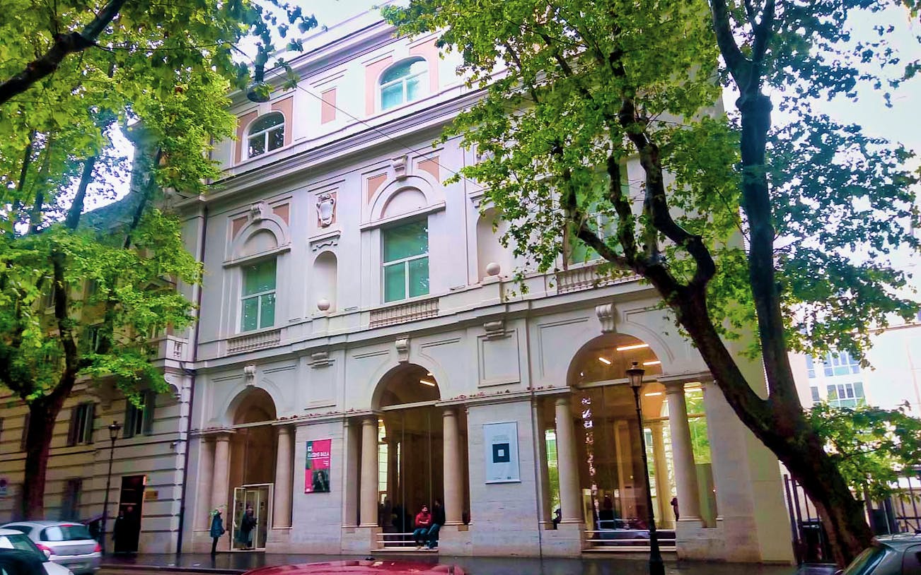 Palazzo Merulana facade with arched windows and columns, Rome, Italy.
