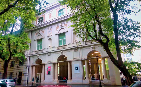 Palazzo Merulana facade with arched windows and columns, Rome, Italy.