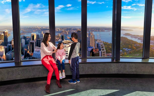 Family enjoying panoramic view from Sydney Tower Buffet Rotating Restaurant.