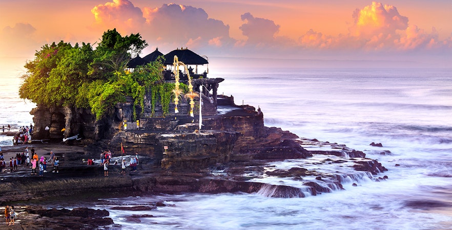 Tanah Lot Temple on a rocky outcrop at sunset, Bali Full Day Tour.