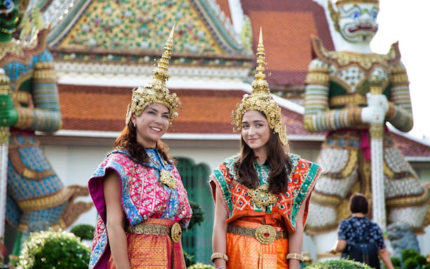 Women in traditional Thai costumes at Wat Arun, Bangkok during Siam Hop-On-Hop-Off Tour.