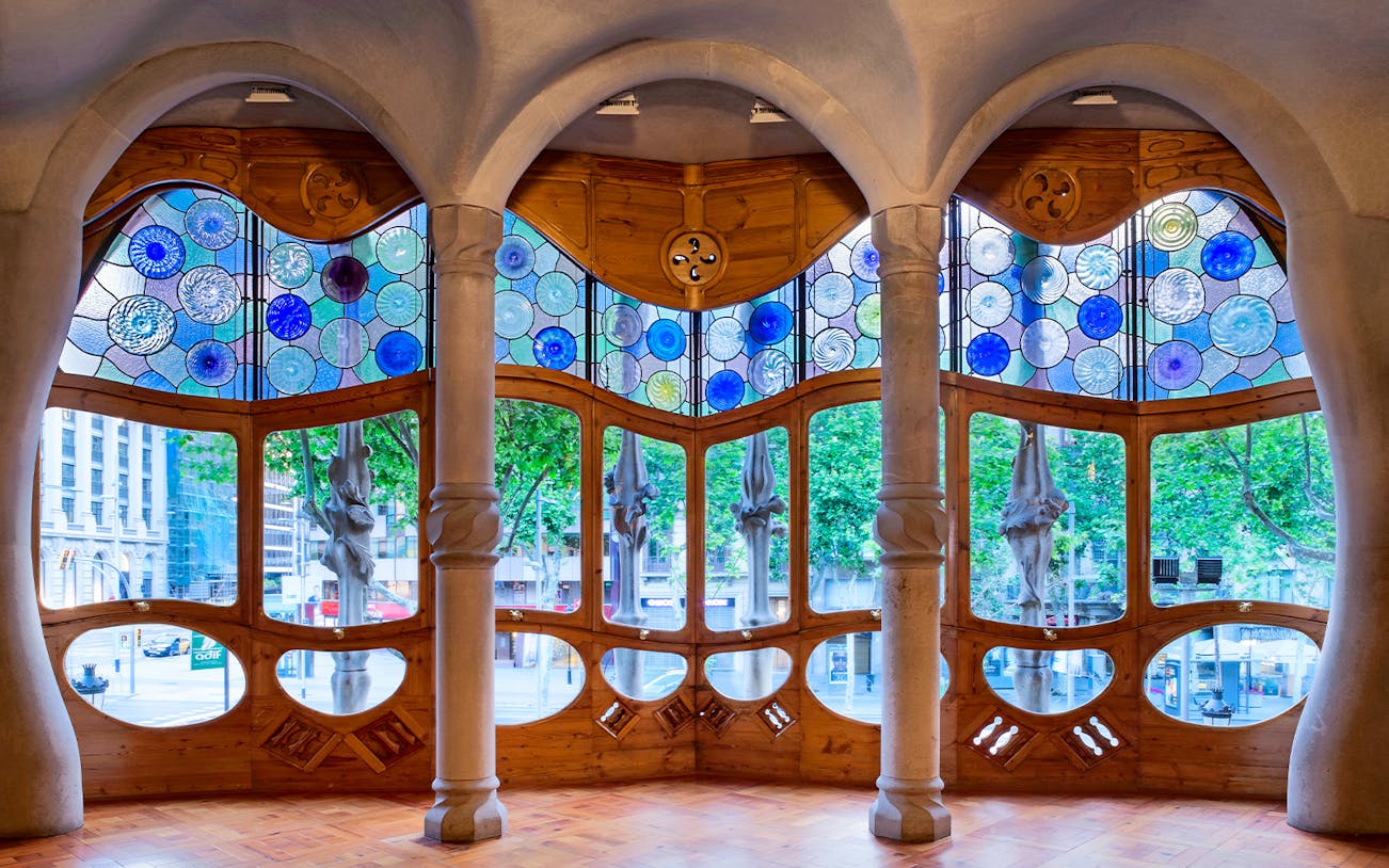 Stained glass windows and unique columns inside Casa Batlló, Barcelona.