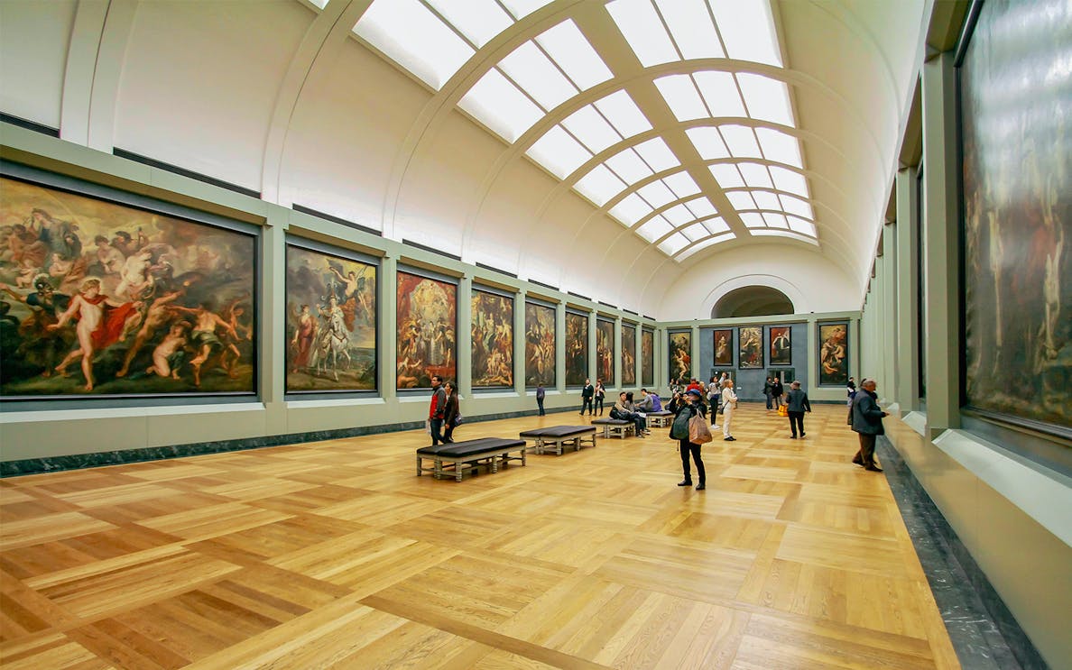 Visitors viewing Luca Giordano paintings at Petit Palais exhibition hall.