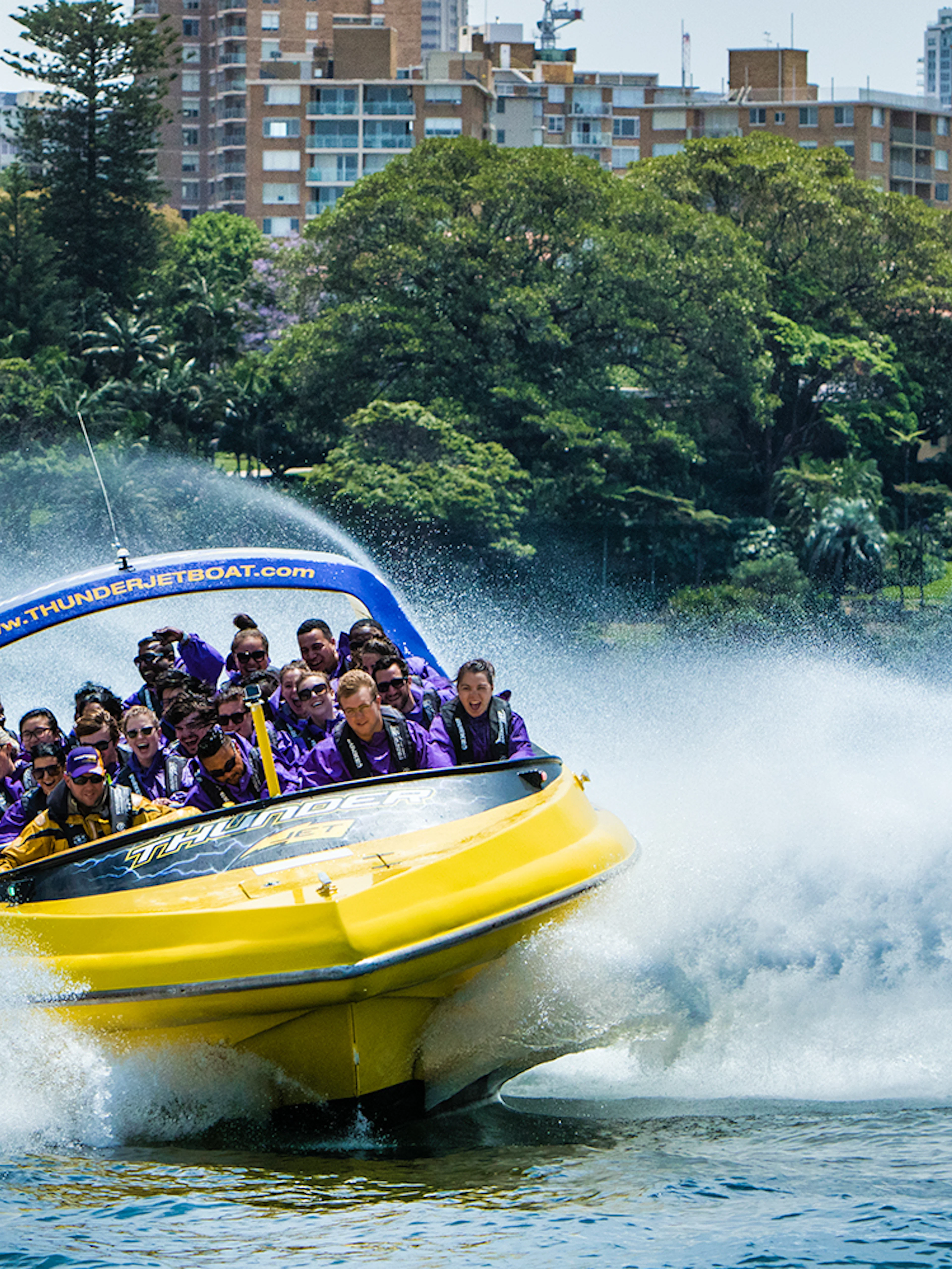 Thunder Jet boat speeding on water with passengers enjoying the ride in Sydney.